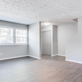 a room with a wood floor and white walls